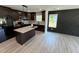 This kitchen features dark wood cabinets, granite countertops, stainless appliances, and a modern kitchen island at 1341 E Atlanta E Rd, Stockbridge, GA 30281