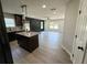 This spacious kitchen with island opens up to a living room with a decorative wall and luxury vinyl plank flooring at 1341 E Atlanta E Rd, Stockbridge, GA 30281