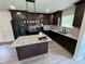 This kitchen features dark wood cabinets, granite countertops, stainless appliances, and a modern kitchen island at 1341 E Atlanta E Rd, Stockbridge, GA 30281
