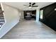 A living room flows into a kitchen with an island and dark cabinets with luxury vinyl plank flooring at 1341 E Atlanta E Rd, Stockbridge, GA 30281