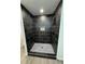 Modern bathroom shower with sleek black tiles and fixtures at 1341 E Atlanta E Rd, Stockbridge, GA 30281