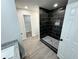 Modern tile shower with overhead rainfall fixture and built-in niche offers a spa-like experience at 1341 E Atlanta E Rd, Stockbridge, GA 30281