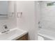 Bathroom vanity with sink next to tiled shower and bath at 1346 Wichita Sw Dr, Atlanta, GA 30311
