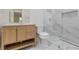Modern bathroom showcasing a marble tiled walk-in shower and wood vanity at 1346 Wichita Sw Dr, Atlanta, GA 30311