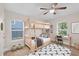 Cozy bedroom features a wooden bunk bed, desk, chair, ceiling fan, and natural light at 1346 Wichita Sw Dr, Atlanta, GA 30311