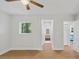 Bright bedroom features modern ceiling fan, hardwood floors, and a sunlit window at 1346 Wichita Sw Dr, Atlanta, GA 30311