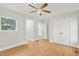 Bedroom with hardwood floors, ceiling fan, and white double door closet provides ample storage at 1346 Wichita Sw Dr, Atlanta, GA 30311