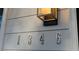 Street numbers 1346 on the outside of the home with a light fixture at 1346 Wichita Sw Dr, Atlanta, GA 30311