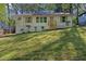 Attractive home with front yard landscaping on a grassy hill at 1346 Wichita Sw Dr, Atlanta, GA 30311