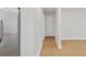 Hallway leading to bright living room with light colored hardwood floors at 1346 Wichita Sw Dr, Atlanta, GA 30311
