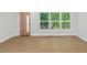 Bright living room with hardwood floors and three large windows at 1346 Wichita Sw Dr, Atlanta, GA 30311