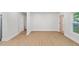 Bright living room with light wood flooring and a modern door with glass inserts at 1346 Wichita Sw Dr, Atlanta, GA 30311