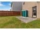 Backyard with a small concrete patio, green shed, grass, and a wooden privacy fence at 5885 San Gabriel Ln, Atlanta, GA 30349