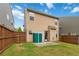 Fenced backyard with grassy lawn, patio, storage shed, and view of the home's rear exterior at 5885 San Gabriel Ln, Atlanta, GA 30349