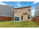 Grassy backyard with a view of the home's back exterior, and featuring a patio and storage shed at 5885 San Gabriel Ln, Atlanta, GA 30349
