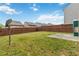 View of the home's backyard featuring a grassy lawn, patio, and privacy fence at 5885 San Gabriel Ln, Atlanta, GA 30349