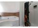 Bathroom featuring a tub with brown tiles and a shower with black shower curtain at 5885 San Gabriel Ln, Atlanta, GA 30349