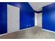 Carpeted bedroom with two white doors, blue walls, trim, and baseboards at 5885 San Gabriel Ln, Atlanta, GA 30349