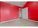 Bedroom featuring carpet, bright red walls, white door with white trim, and baseboards at 5885 San Gabriel Ln, Atlanta, GA 30349