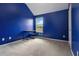 Bedroom with carpet flooring, blue walls, window with a view, baseboards, and door at 5885 San Gabriel Ln, Atlanta, GA 30349