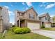 Charming two-story home featuring a brick and neutral toned facade, a two-car garage, and a well-maintained lawn at 5885 San Gabriel Ln, Atlanta, GA 30349
