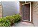 Front door featuring brick surround and landscaped bushes at 5885 San Gabriel Ln, Atlanta, GA 30349