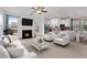 Open concept living room with fireplace, white seating, and modern lighting at 5885 San Gabriel Ln, Atlanta, GA 30349