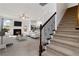 Cozy living room with fireplace, stairs, and open-concept kitchen at 5885 San Gabriel Ln, Atlanta, GA 30349
