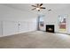 Unfurnished living room features a fireplace, neutral carpet, and ample natural light at 5885 San Gabriel Ln, Atlanta, GA 30349