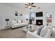 Bright living room with cozy fireplace, ceiling fan and plush seating arrangement at 5885 San Gabriel Ln, Atlanta, GA 30349