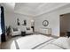 A luxurious main bedroom featuring natural light, neutral decor, and a seating area at 5885 San Gabriel Ln, Atlanta, GA 30349