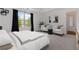 A spacious main bedroom featuring natural light, neutral decor, and a seating area at 5885 San Gabriel Ln, Atlanta, GA 30349