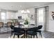 Dining area with a glass table looks into modern kitchen and bar seating at 616 Devon Aly, Acworth, GA 30102