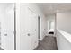 Bright hallway with neutral carpet, white doors, and a view into a bedroom at 616 Devon Aly, Acworth, GA 30102