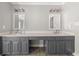 Bright bathroom featuring a double sink vanity with dark cabinets and tile flooring at 7389 Tidewater Trce, Stone Mountain, GA 30087