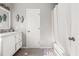 Bright bathroom featuring a single sink vanity, tub and shower combo and tile flooring at 7389 Tidewater Trce, Stone Mountain, GA 30087