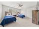 Spacious bedroom featuring two twin beds, ceiling fan, and double door closet at 7389 Tidewater Trce, Stone Mountain, GA 30087