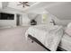 Bright bedroom featuring carpet flooring, flat screen TV, and multiple windows at 7389 Tidewater Trce, Stone Mountain, GA 30087