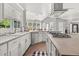 Beautiful white kitchen with stainless appliances, stone countertops and views to the living room at 7389 Tidewater Trce, Stone Mountain, GA 30087