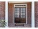 Elegant brick home entrance featuring custom wood double doors with decorative glass and column accents at 4065 Tritt Homestead Dr, Marietta, GA 30062