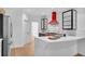 Bright, white kitchen with stainless steel appliances, quartz countertops, and a red range hood at 4065 Tritt Homestead Dr, Marietta, GA 30062