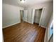Bedroom features wood-look floors, natural light, and a closet for storage at 774 Mill Rd, Mcdonough, GA 30253