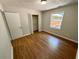 Bedroom boasts wood floors, natural light, and an organized closet, great for storage and style at 774 Mill Rd, Mcdonough, GA 30253
