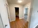 Hallway featuring laminate floors, neutral walls, and an open view of the bathroom and bedroom at 774 Mill Rd, Mcdonough, GA 30253