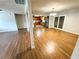 Open concept living room featuring laminate floors with view to the kitchen, stainless steel appliances, and patio doors at 774 Mill Rd, Mcdonough, GA 30253