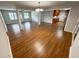 Open-concept living room showcases hardwood floors, natural light, and a seamless flow to the dining and kitchen areas at 774 Mill Rd, Mcdonough, GA 30253