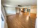 Spacious living room featuring hardwood floors, a ceiling fan, and seamless transitions to the kitchen and dining areas at 774 Mill Rd, Mcdonough, GA 30253