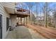 Backyard with concrete patio, view of deck, and natural landscape at 1810 Valley Brook Dr, Alpharetta, GA 30005