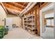 Basement storage with exposed rafters, shelving with canned goods, and utility components at 1810 Valley Brook Dr, Alpharetta, GA 30005
