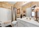 Neat bathroom featuring a vanity with sink, toilet, shower with curtain and decorative wallpaper at 1810 Valley Brook Dr, Alpharetta, GA 30005